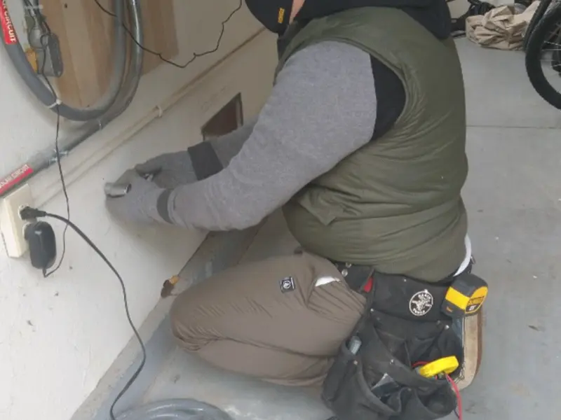 Electrician performing outlet wiring in a Chisago City garage