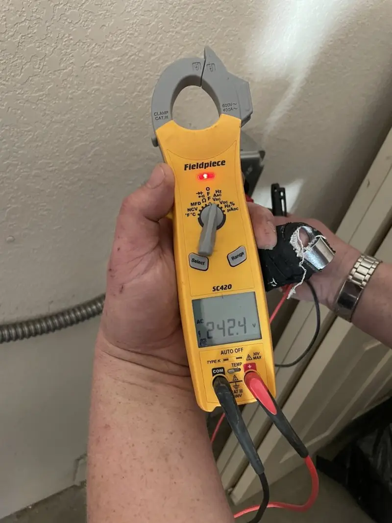Voltage testing with clamp meter during Outlet Installation in Chisago City